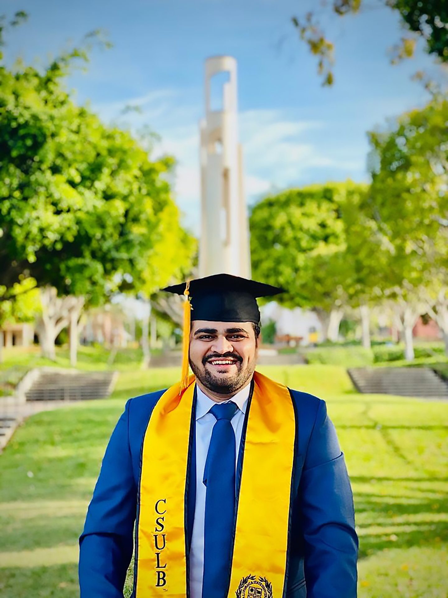 Academic dress, Smile, Sky, Yellow, Mortarboard, Grass