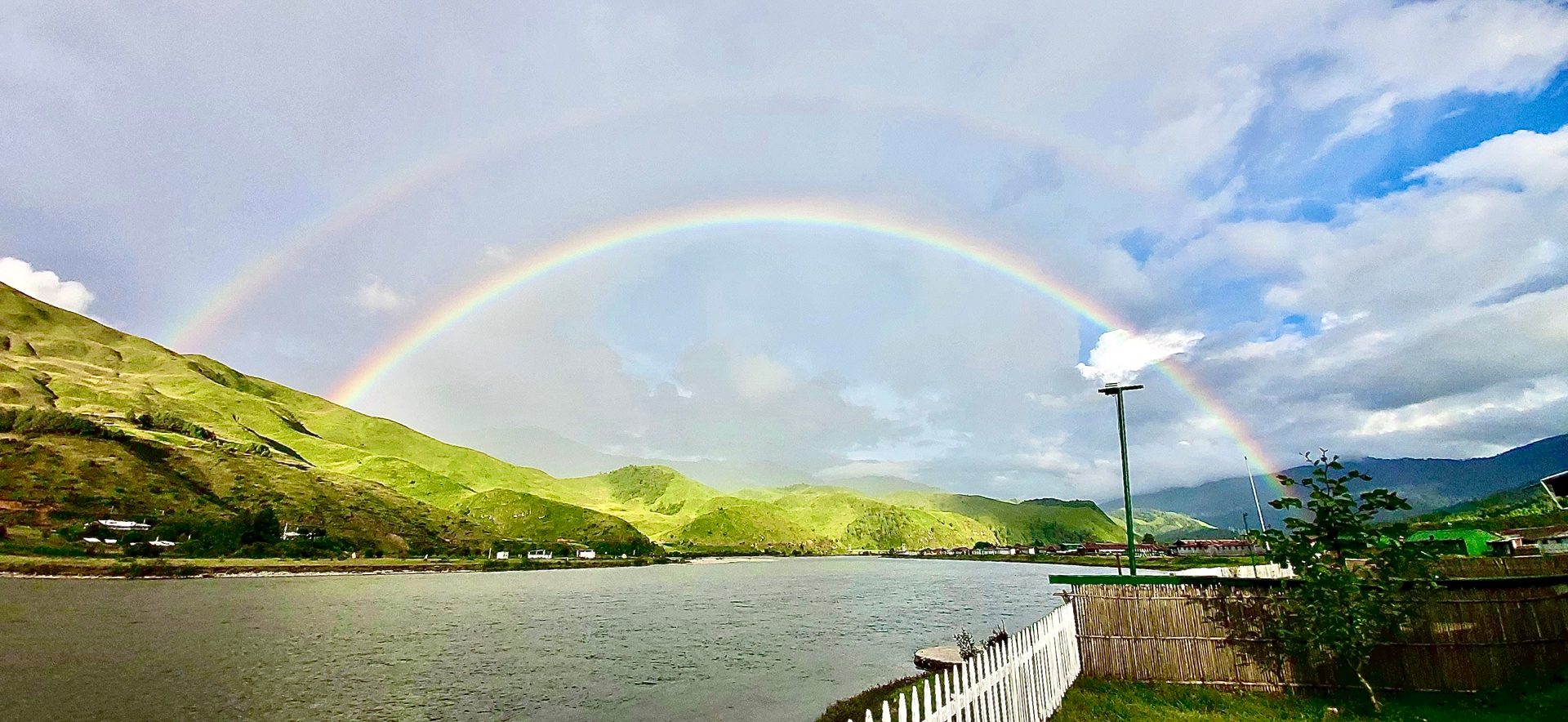 Water resources, Natural landscape, Rainbow, Sky, Cloud, Daytime, Ecoregion, Green, Mountain