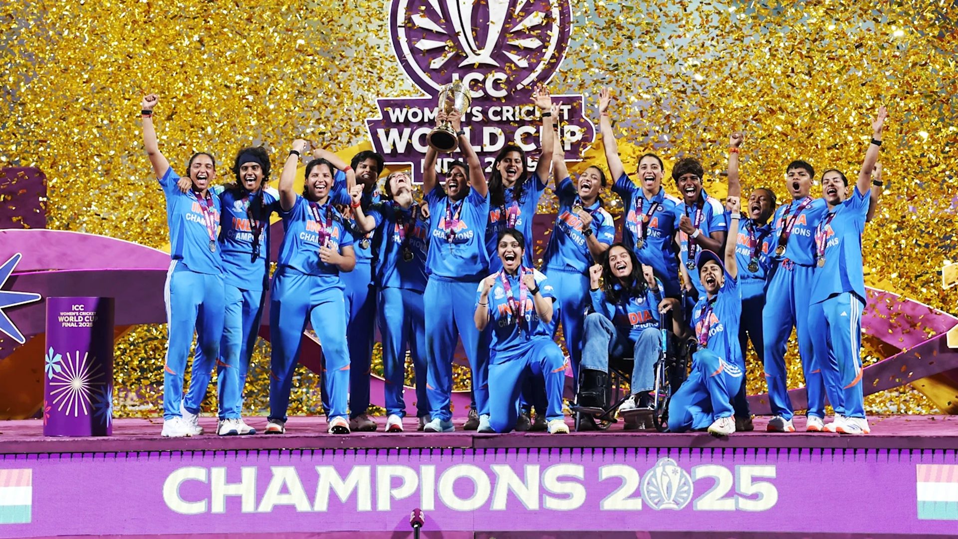 India women's cricket team celebrating World Cup 2025 win with trophy and confetti.