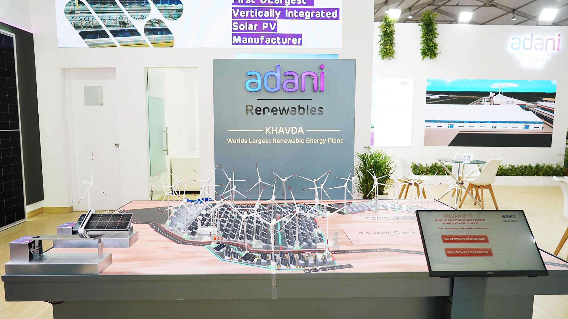 Adani Renewables exhibit featuring a detailed model of the Khavda World's Largest Renewable Energy Plant.