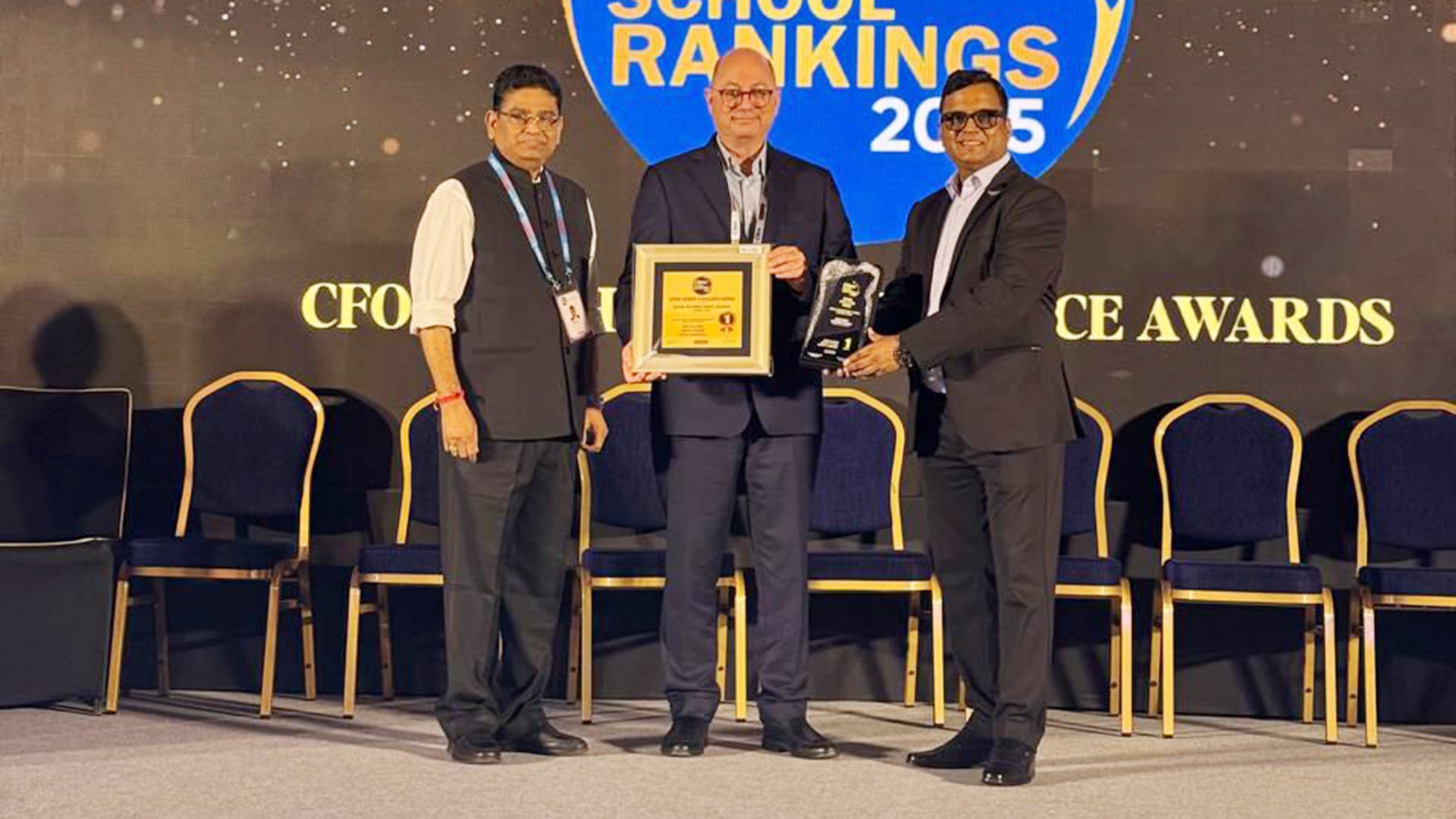 Three men on stage accept awards, with "SCHOOL RANKINGS 2025" and "CFO CE AWARDS" in the background.
