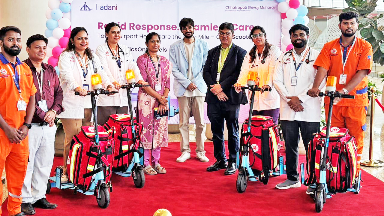 A group of medical staff and others stand with rapid response medical scooters at an airport event.