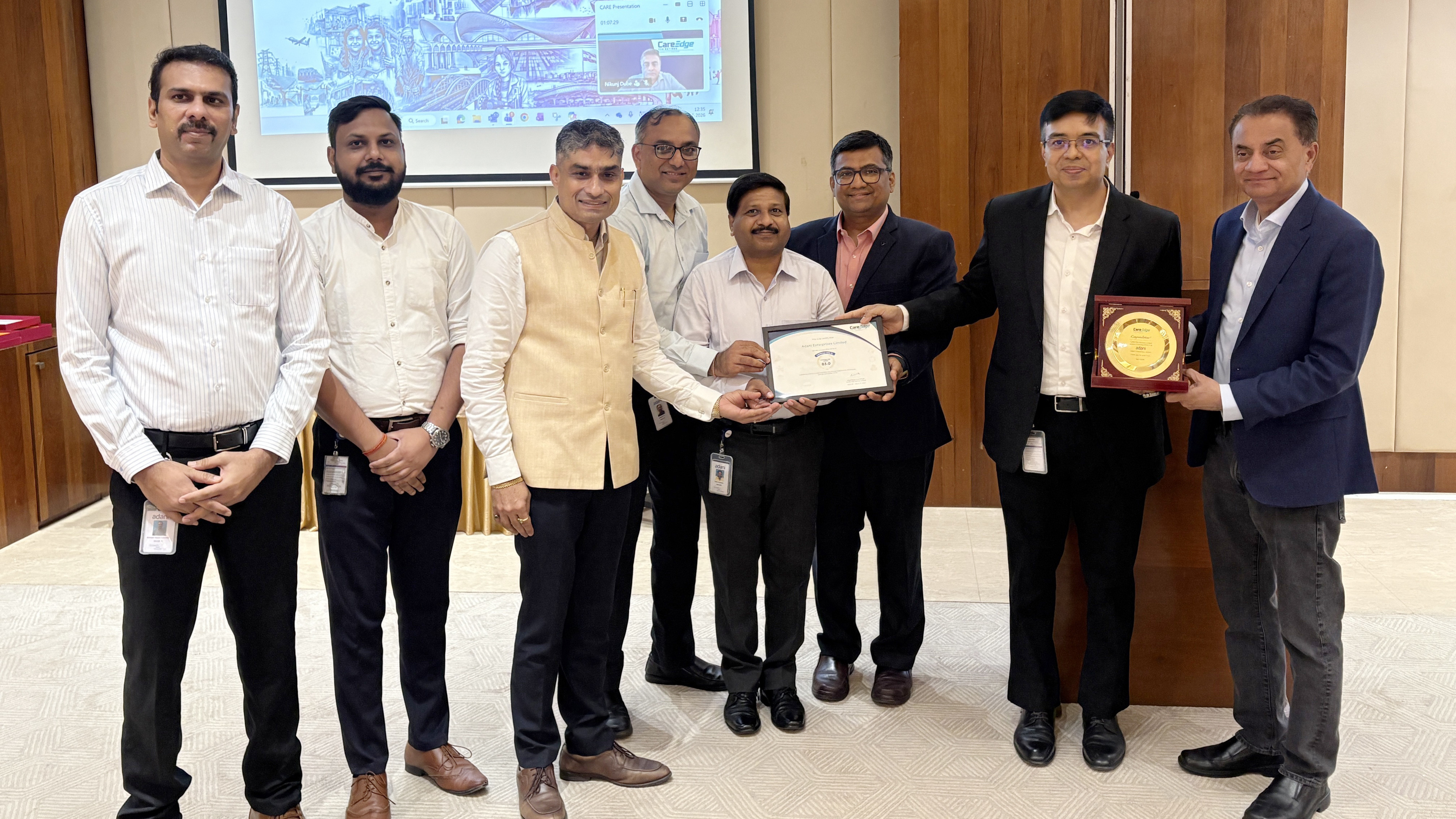 Eight men in professional attire participating in an award ceremony, receiving certificates and plaques.