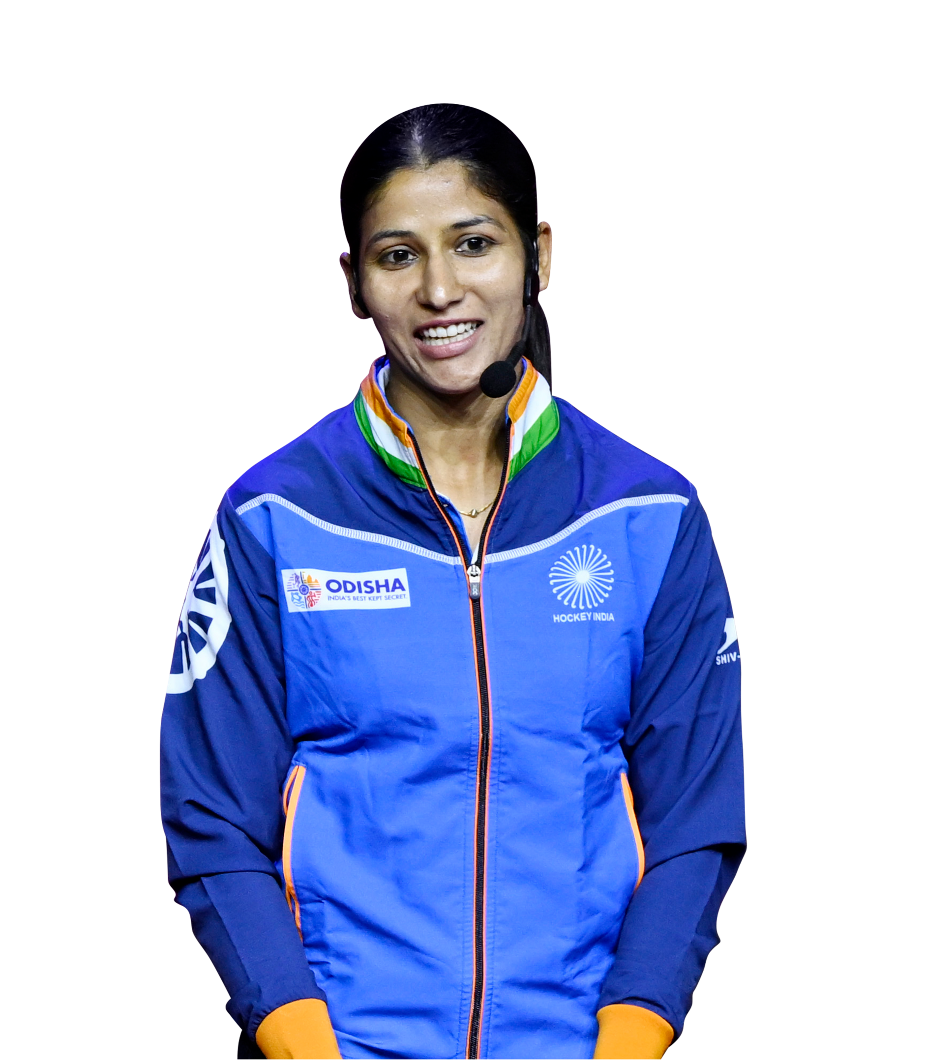 Smiling Indian woman in blue hockey jacket and headset, possibly a coach or athlete.