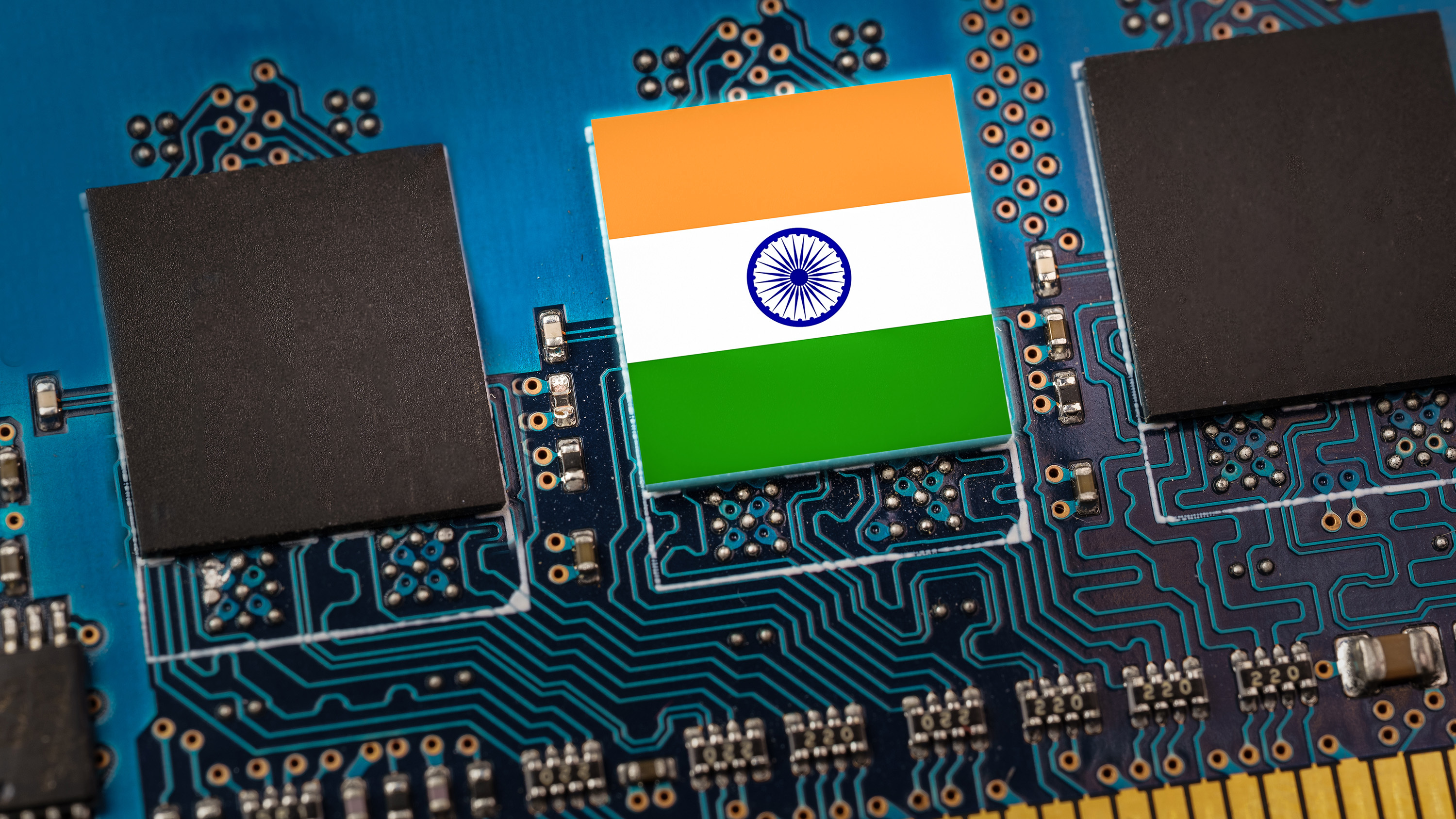 Indian flag on a computer chip embedded in a blue circuit board, symbolizing India's tech growth.