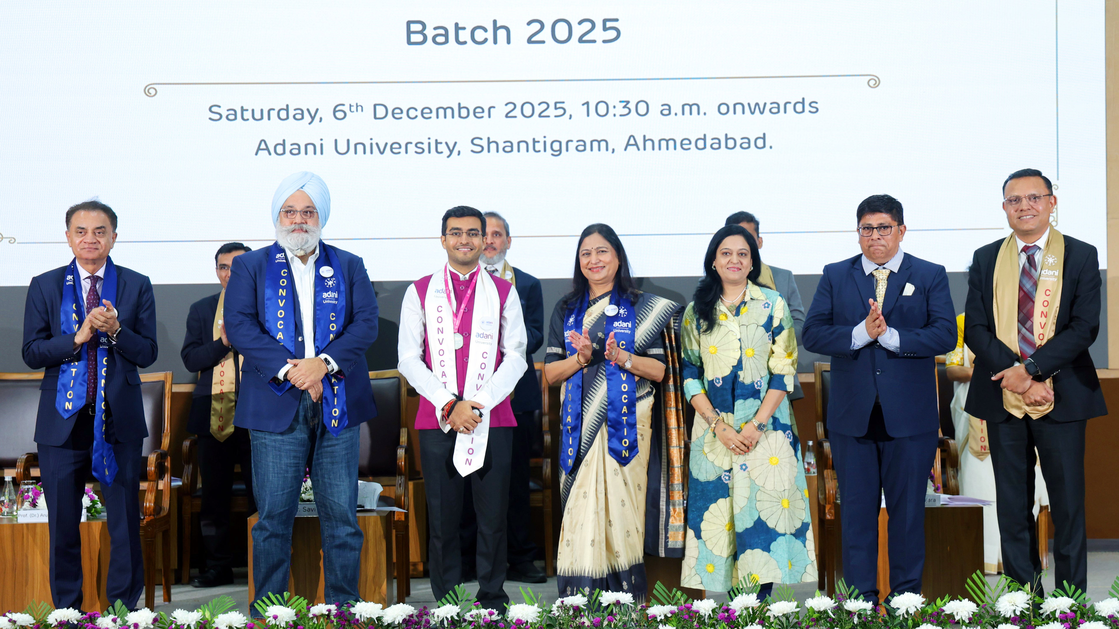 Group of people on stage at the Adani University Batch 2025 Convocation ceremony.