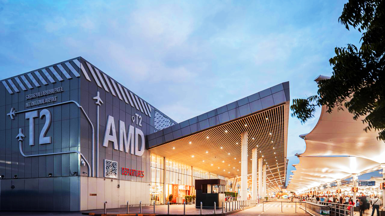 Exterior of Sardar Vallabhbhai Patel International Airport T2 (AMD) at dusk.