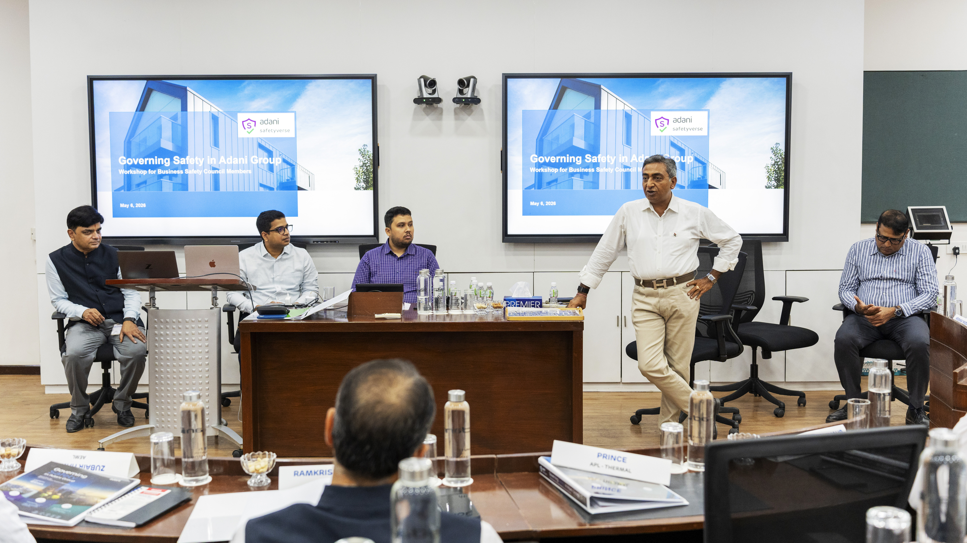 Workshop on "Governing Safety in Adani Group" with a speaker presenting and attendees listening.