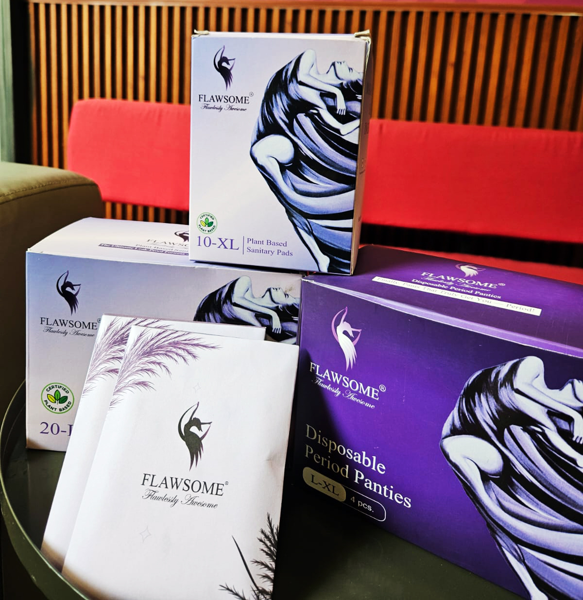 Flawsome brand plant-based sanitary pads and disposable period panties in packaging.