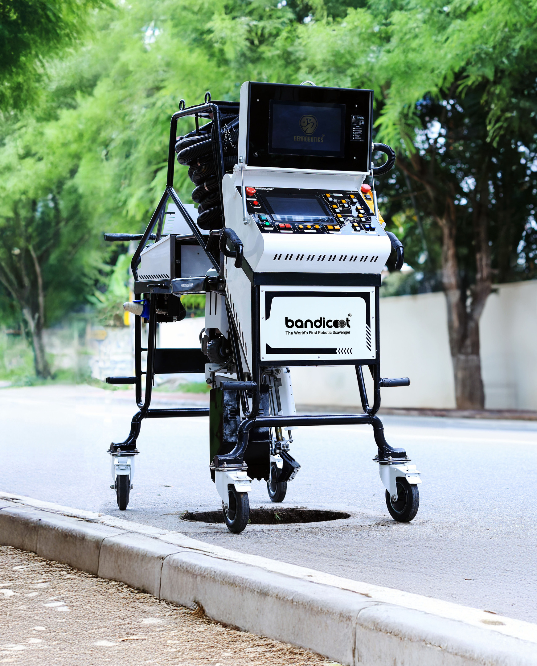 Bandicoot robotic sewer cleaning machine on a street, positioned over a manhole.