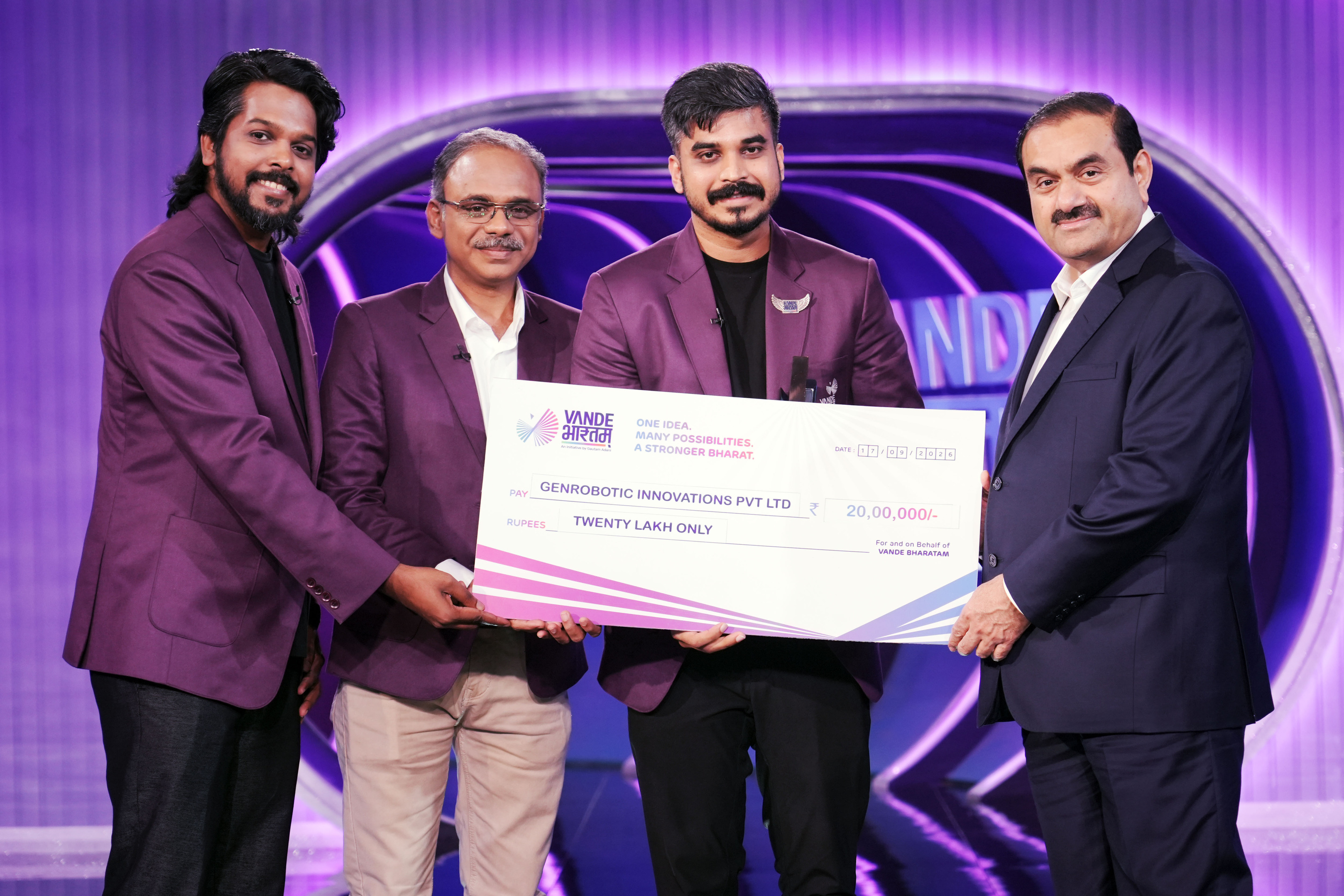 Four men, including Gautam Adani, presenting a large check for ₹20,00,000 to Genrobotic Innovations.