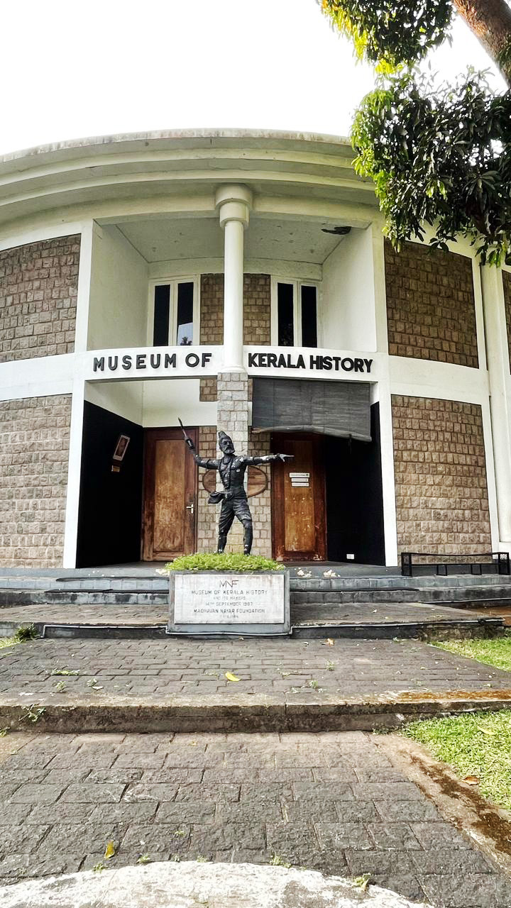 Exterior of Museum of Kerala History with a historical statue at the entrance.