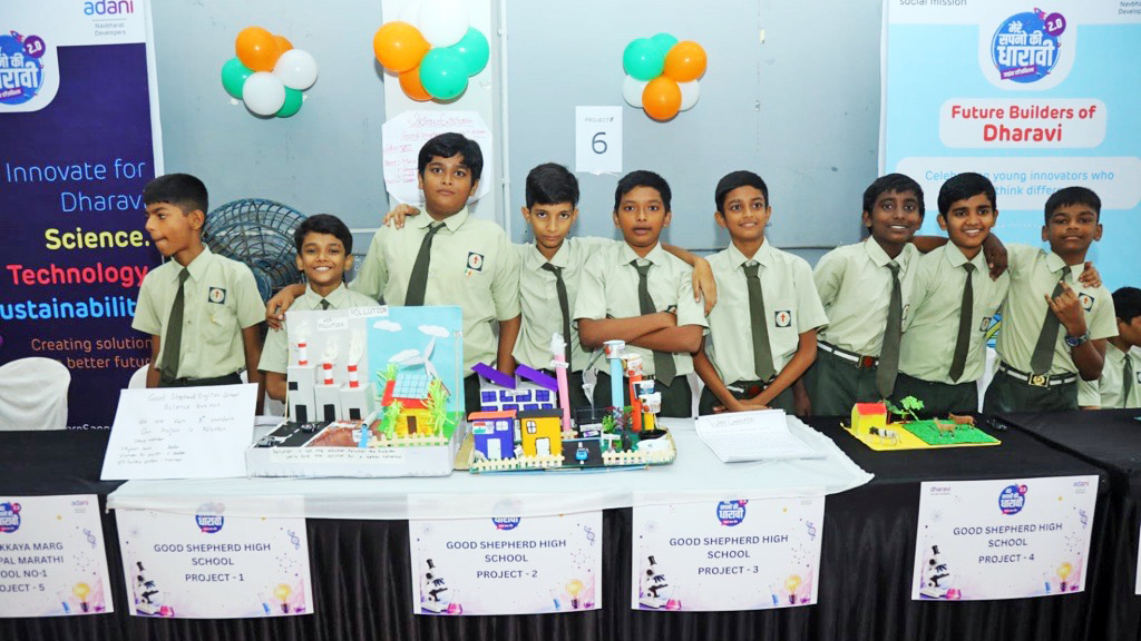 School boys in uniform showcase their science projects at an exhibition.