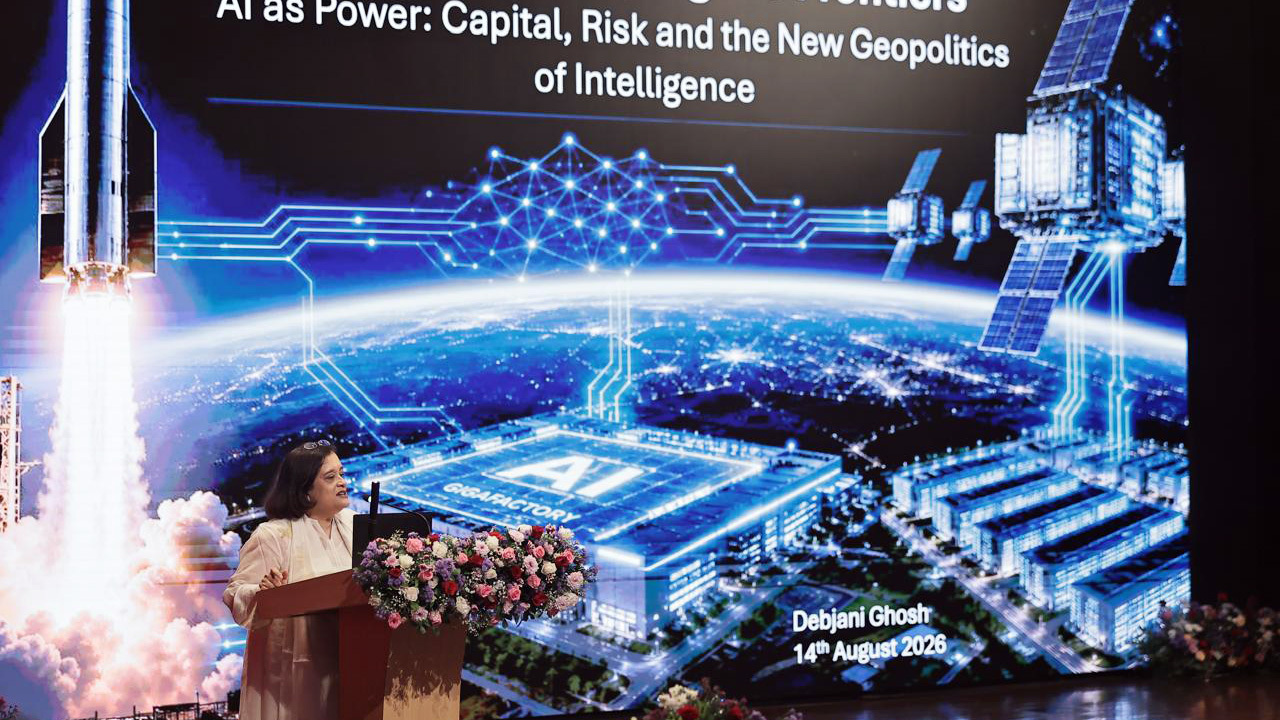 Debjani Ghosh presenting "AI as Power" with a backdrop of a rocket, satellites, and an AI gigafactory.