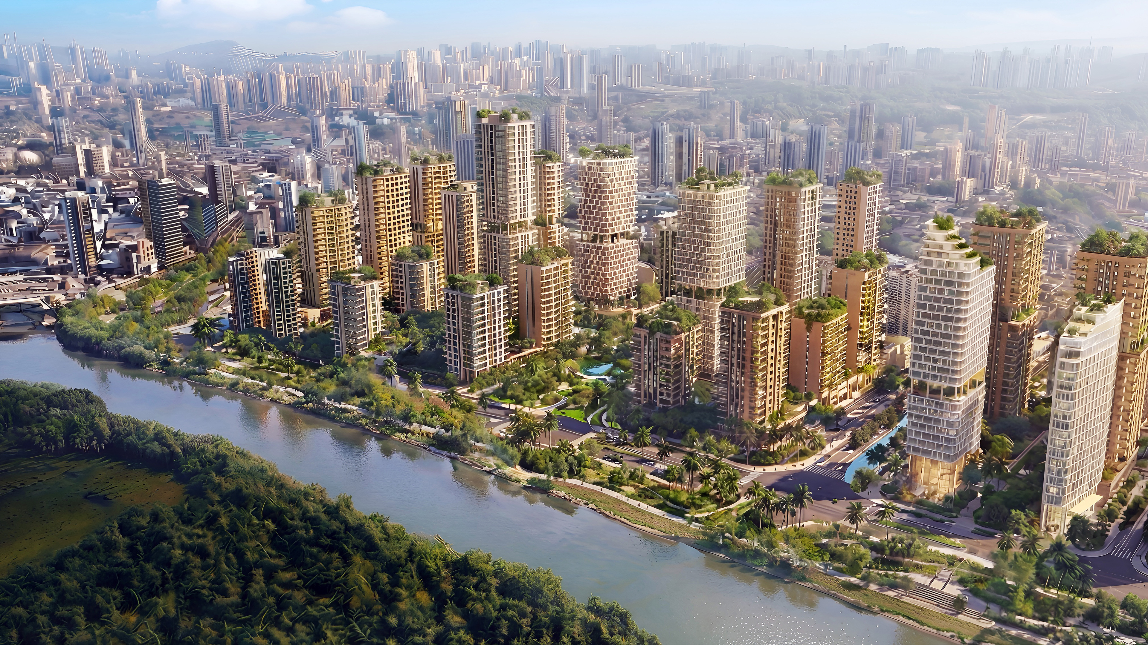 Aerial view of a modern city with high-rise buildings and green roofs along a winding river and lush parks.