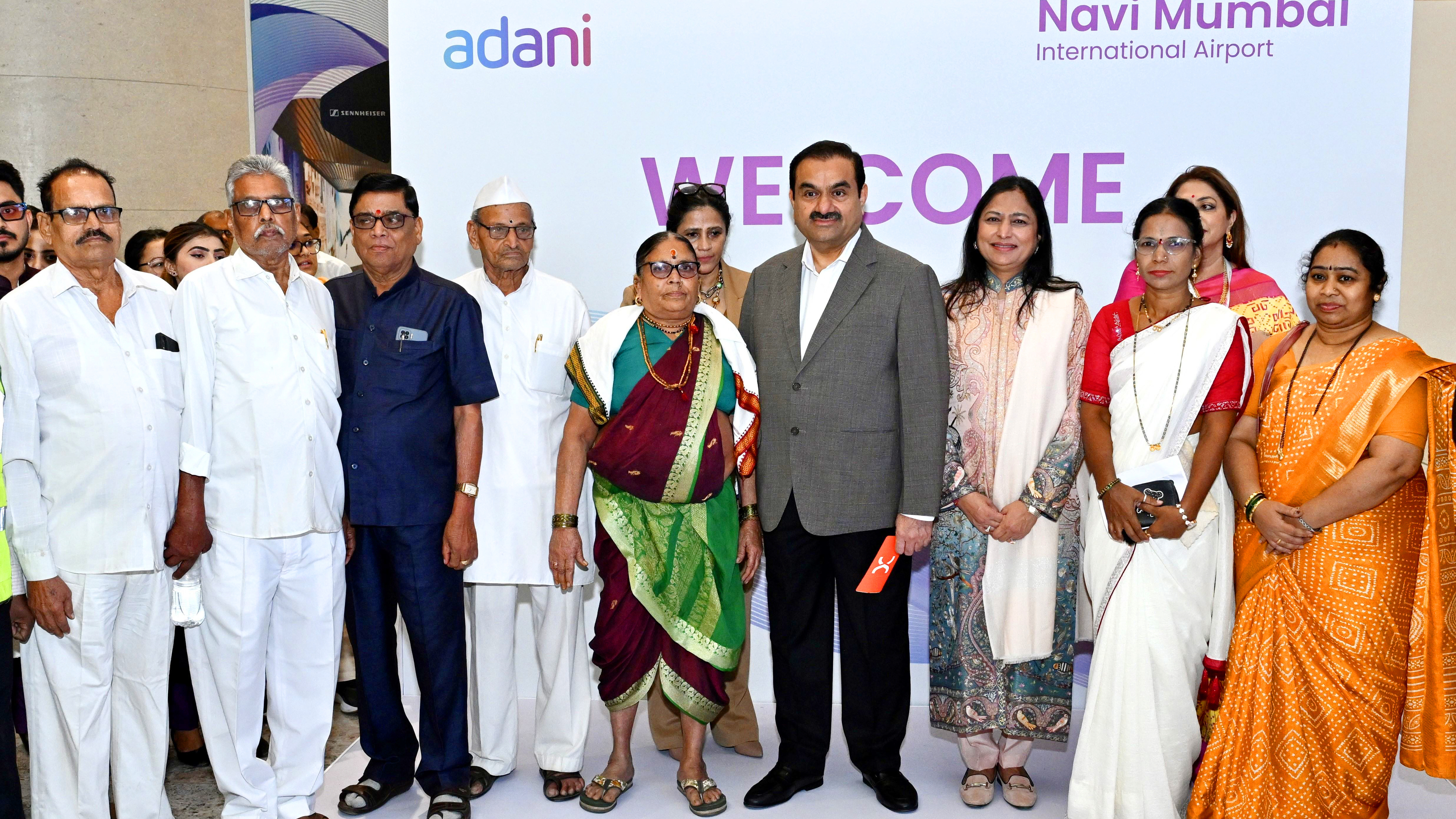 Gautam Adani and a group of people at the Navi Mumbai International Airport event.