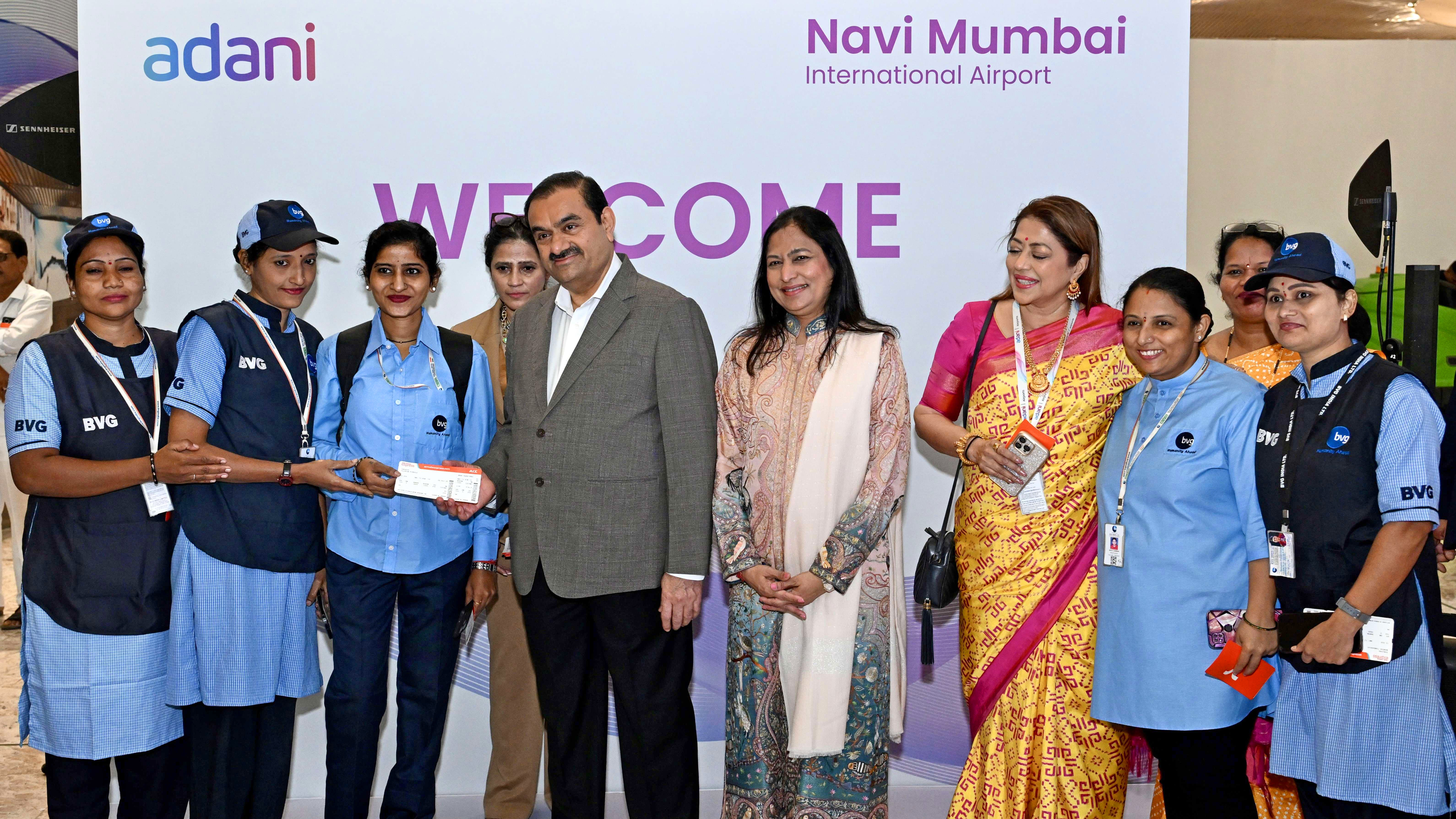 Gautam Adani and his wife at an Adani Navi Mumbai Airport event with BVG staff.