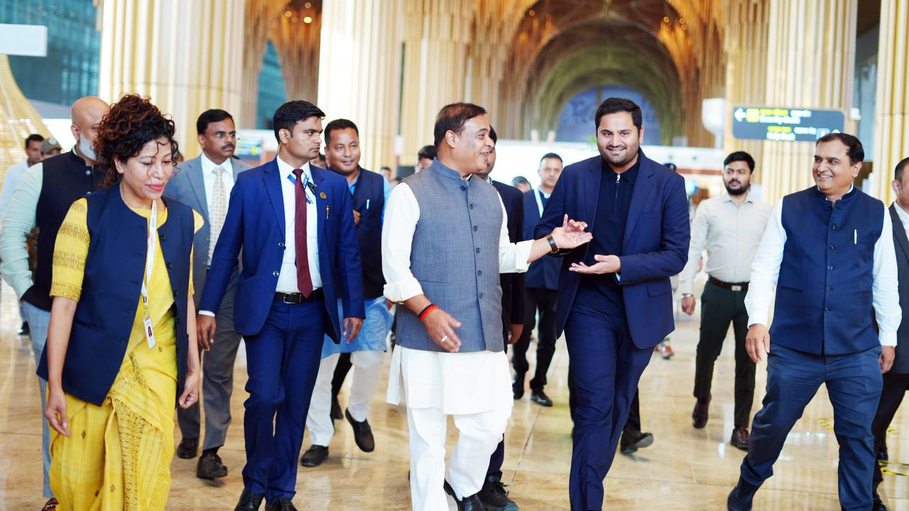 Himanta Biswa Sarma, Kalparvind Parekh, and other officials walking in a modern building.