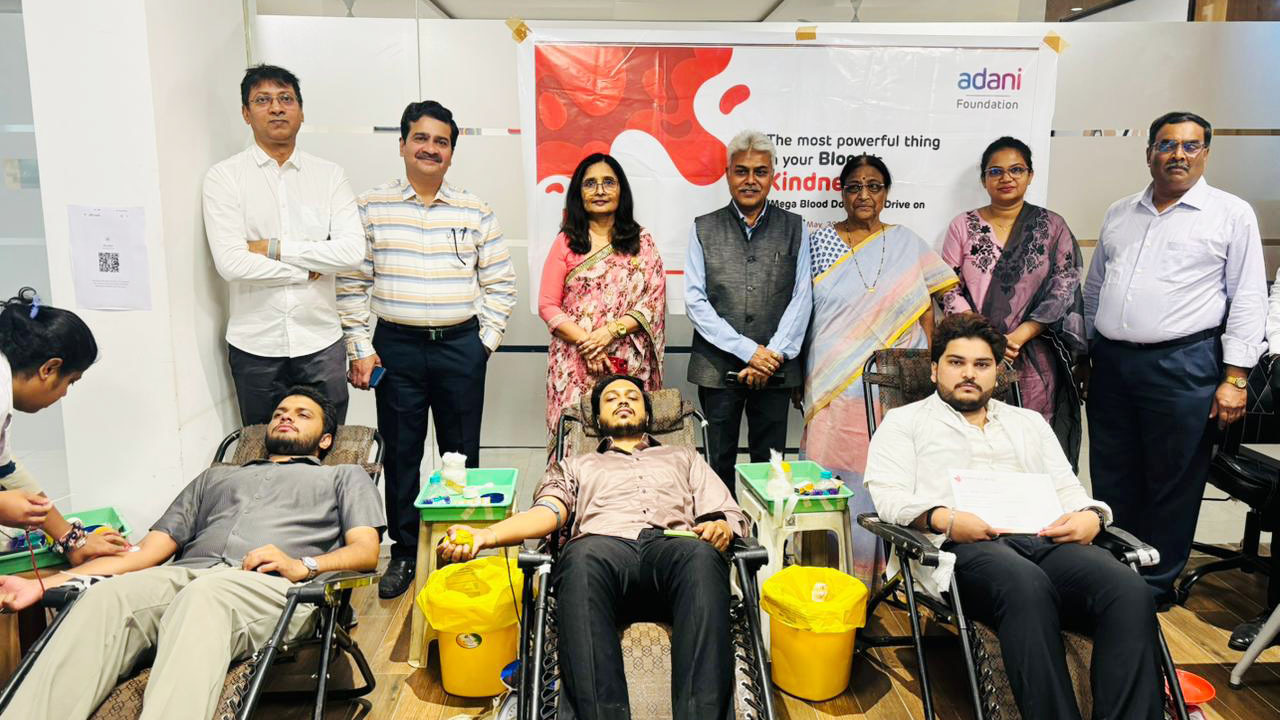 People at an Adani Foundation blood donation drive, with donors and organizers present.