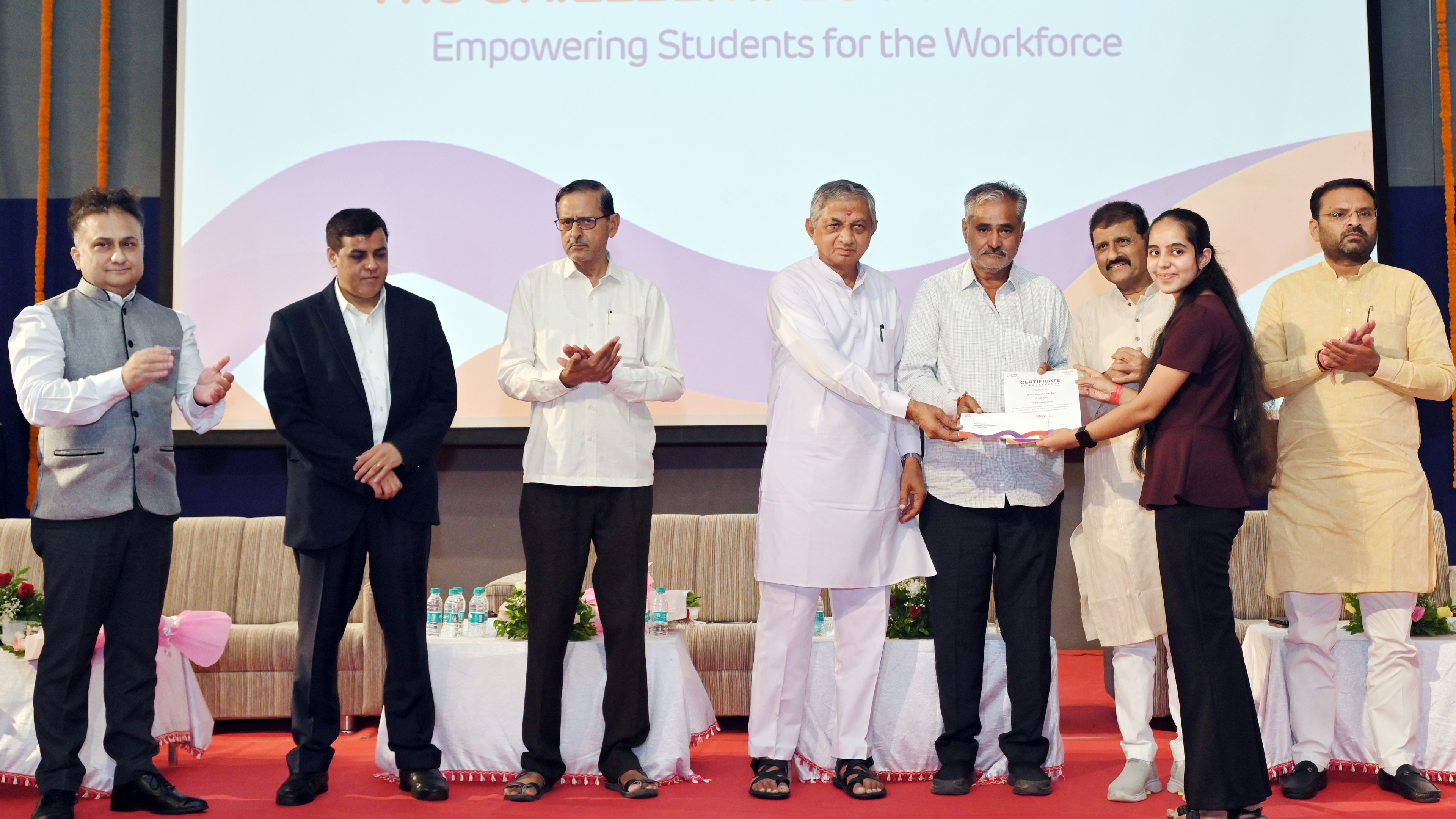 Officials award certificates to students at a skill empowerment event for workforce development.